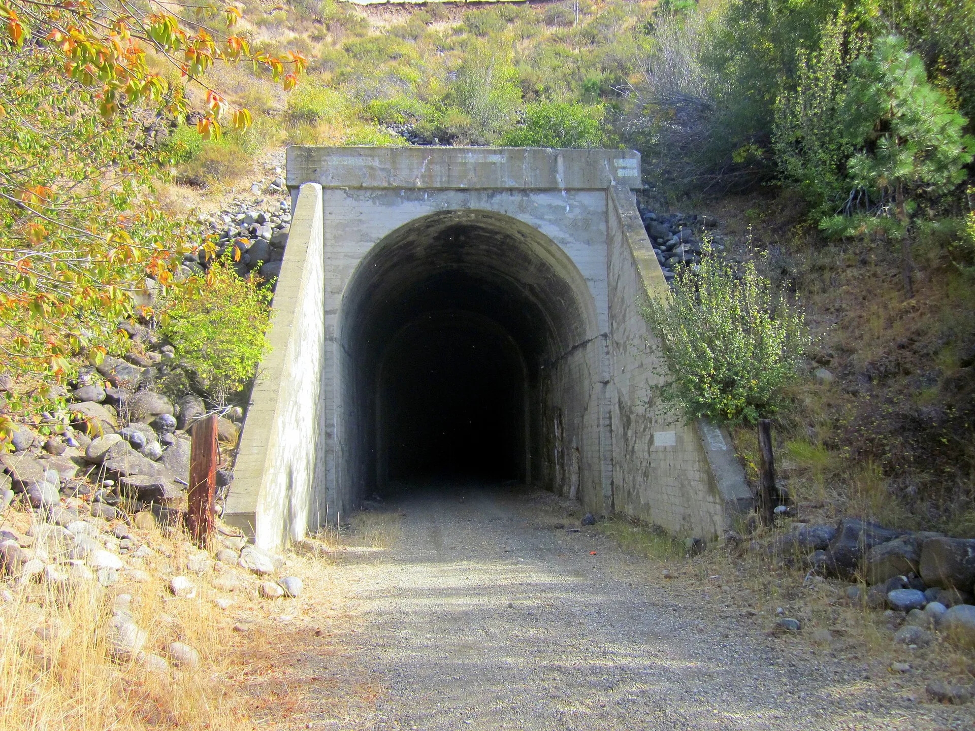 Entering 1/4-mile long tunnel on John Wayne Pioneer Trail. USA travel: asking about rail-trail access