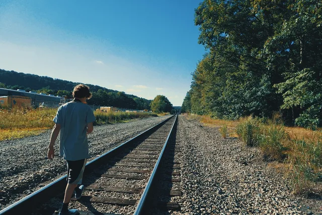 trail, rail, station, train, nature, man, alone, people, rocks, woods, forest, clouds. How to Photograph a Rail Trail Town Without Holding Up the Group
