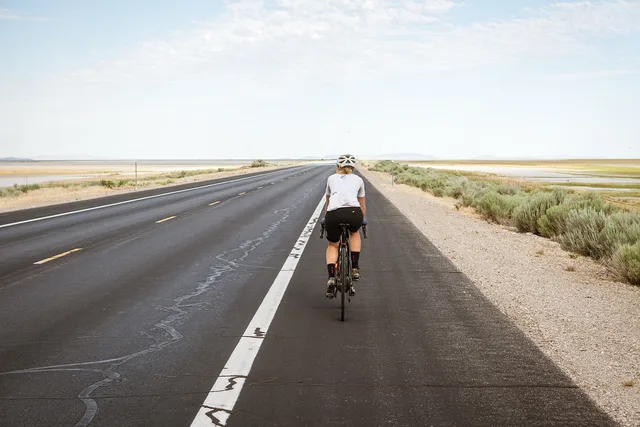 cyclist, cycling, biking, bike riding, road, pavement, highway, asphalt road, desert, bike, bicycle, exercise, leisure, fitness, activity, sport, nature, outdoors, woman. US cyclists crossing into Canada: what to declare at the booth